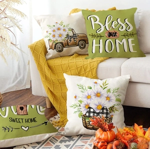 Detail of four farmhouse style linen pillow covers with vintage truck and home quotes