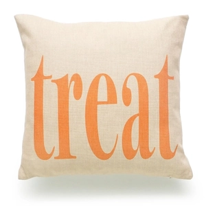 Macro detail of beige linen fabric texture and orange treat print on halloween pillowcase