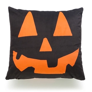Detail of Halloween pumpkin pillow cover featuring a black base and orange Jack-o'-lantern face