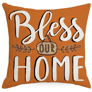 Close-up of caramel orange pillow case with Bless OUR HOME text and fabric texture