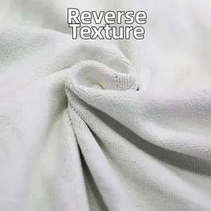 Macro detail of the white microfiber beach towel showing soft looped back texture
