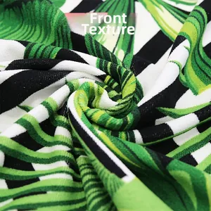Macro view of soft microfiber beach towel showing palm leaf texture and white stripes