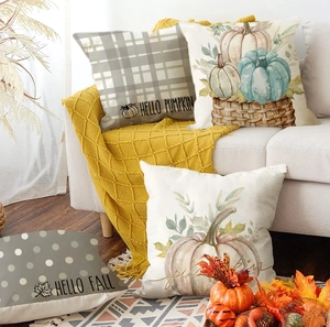 Close-up of four linen Thanksgiving pillow covers with pumpkins and autumn motifs