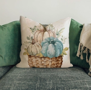 Close-up of linen Thanksgiving pillowcase with watercolor pumpkins on a green velvet sofa