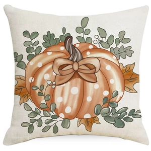 Close-up of linen pillowcase with orange polka dot pumpkin and autumn maple leaf prints