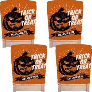 Detail view of 4-piece orange Halloween chair covers with black pumpkin and spider prints