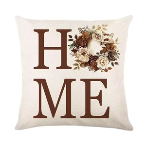 Detail of floral HOME print on square linen pillowcase with natural fabric texture