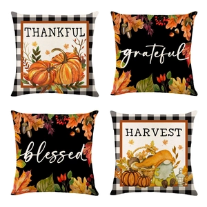 Detail of four linen fall pillow covers with gnomes pumpkins and grateful quotes