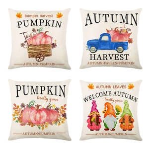 Detail view of four linen pillow covers with autumn pumpkin and gnome watercolor prints
