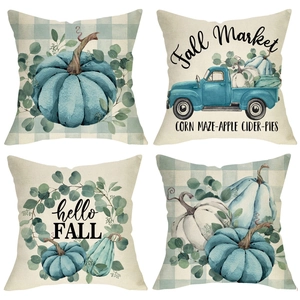 Detail of four linen fall pillow covers with watercolor pumpkin and truck patterns