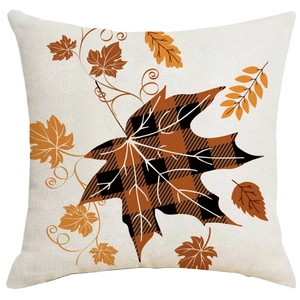 Fall harvest throw pillow cover with orange maple leaves and plaid patterns on linen