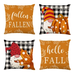 Detailed view of four autumn pillow covers with pumpkin gnomes and orange leaf prints