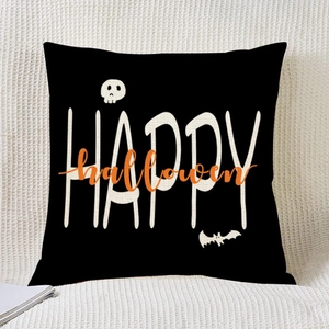 Close-up of Halloween pillow cover with Happy Halloween print, skull and bat details