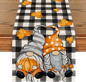 Detail of linen table runner with fall gnomes, pumpkins and maple leaves on buffalo plaid