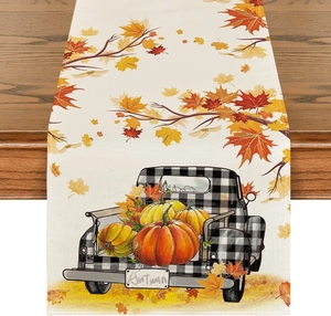 Detailed texture of linen table runner with pumpkins and maple leaves for Thanksgiving