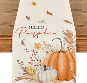 Detail of linen table runner with pumpkins, maple leaves and HELLO Pumpkin text