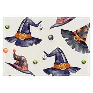 Detail of Halloween placemat showing watercolor witch hats and fine stitching on linen