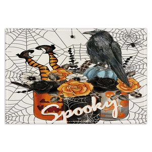 Detail of Halloween placemat with pumpkin, crow and rose patterns on linen fabric