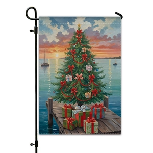 Christmas garden flag with tree and sunset sea view hanging on black metal stand