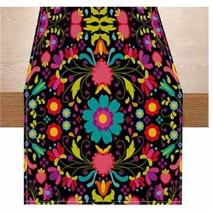 Detail of colorful folk floral pattern and heart print on a black fabric table runner