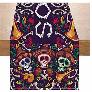 Detail of Day of the Dead table runner with colorful skulls and musical instruments