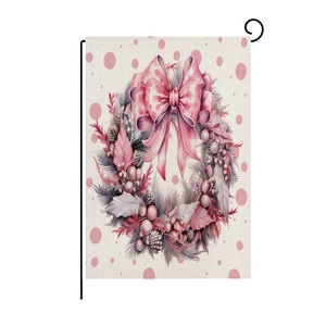 Close-up of pink Christmas garden flag with wreath and bow on a metal stand