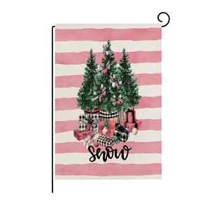 Detail of pink striped garden flag with Christmas trees and black metal stand