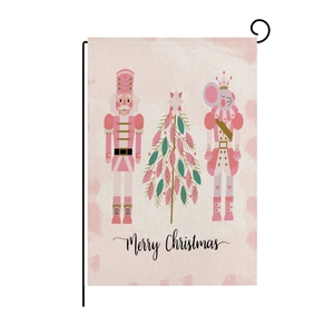 Detailed view of pink Nutcracker garden flag with Merry Christmas text on burlap