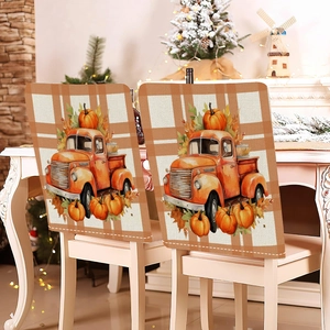 Detail of harvest pumpkin and vintage truck printed on autumn plaid dining chair covers