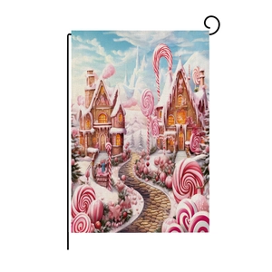 Detail of a candy house garden flag with winter elements on a black metal spiral hanger
