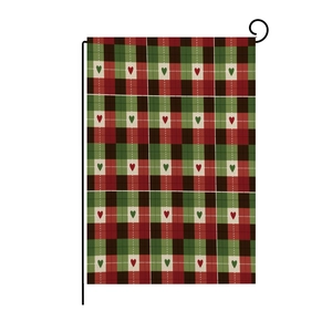 Garden flag detail showing red and green plaid pattern with small hearts and metal L-bracket
