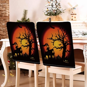 Close-up of Halloween chair covers featuring silhouettes of castles and bats on dining chairs