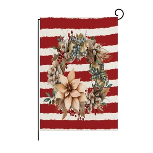 Close-up of linen garden flag with poinsettia wreath and black metal hanging hook