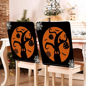 Detail of Halloween chair covers with orange moon, bats and ghosts on black fabric