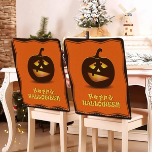 Detailed close-up of two orange Halloween pumpkin chair covers with Happy Halloween text