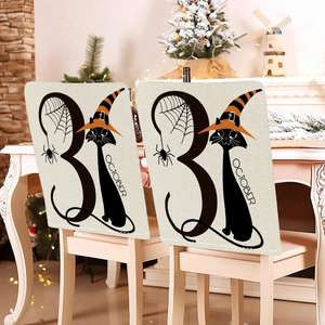Detail of Halloween chair covers featuring a black cat, spider webs, and October 31 design