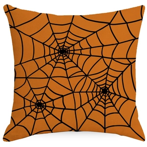 Close-up of square orange linen pillowcase with black spider web patterns for Halloween