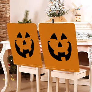 Set of 2 orange linen Halloween chair covers with classic Jack-o'-lantern pumpkin faces