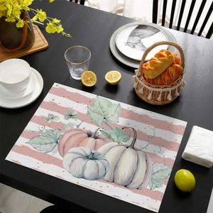 Detailed top view of a woven placemat with white pumpkins and maple leaf autumn motif