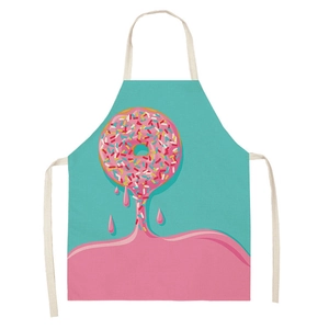 Close-up of cotton linen apron with pink donut print and white neck straps
