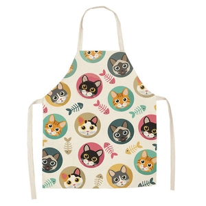 Linen kitchen apron featuring cute cartoon cat and fish bone prints on a white background