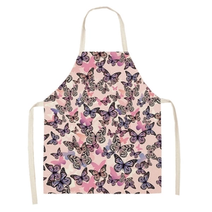 Detail of pink kitchen apron featuring purple butterfly prints and neck strap design