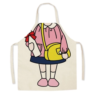 Detail of linen apron featuring a cute cartoon girl print with neck strap and waist ties