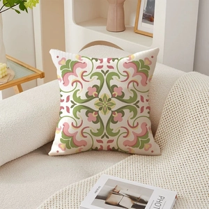 Detailed macro view of the floral embroidery and textured linen fabric of the cushion cover