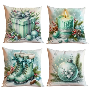 Set of four mint green Christmas pillow covers with holiday gift and candle patterns