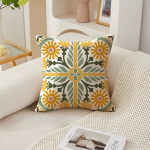 Luxury floral throw pillow cover with yellow and green patterns on a soft beige sofa