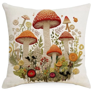 Detail of 3D forest mushroom and bird embroidery on a square linen pillowcase