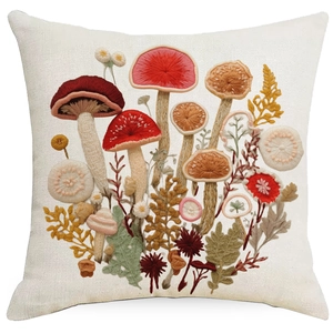 Detailed view of linen pillowcase with 3D embroidery style mushroom and floral patterns