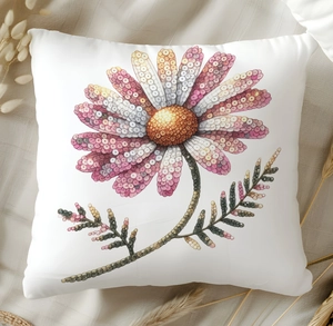 Detailed view of white throw pillow with colorful glitter floral pattern on fabric surface