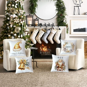 Set of four Christmas pillow covers with Santa Claus and festive watercolor prints on sofa